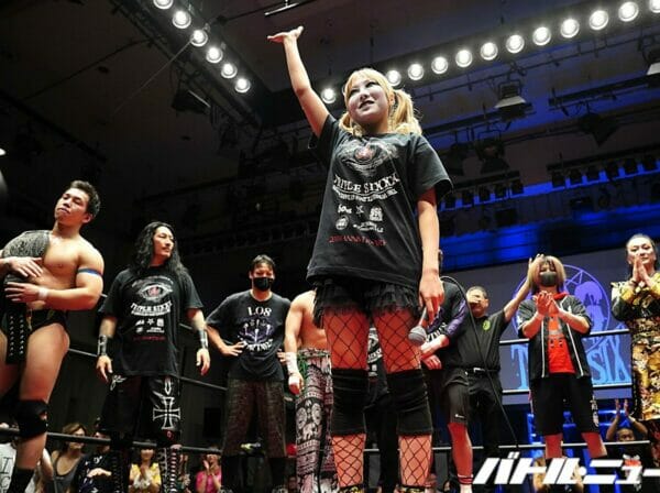 Un grupo de luchadores mostrando el 666 en un escenario.