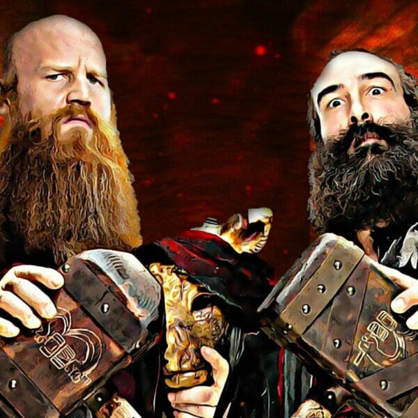 Dos luchadores barbudos sosteniendo libros en la coronación de WrestleMania 34.