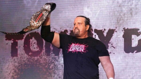 Superlucho - A victorious fighter with a belt in front of a crowd that cheered him in Impact! Final Resolution 2023.