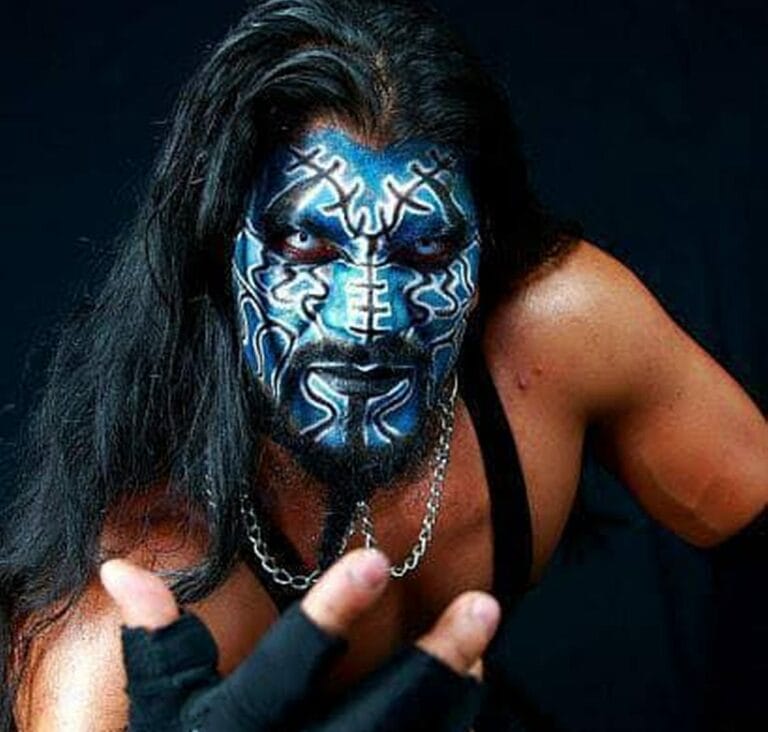 Superluchas - Dark Ozz, un hombre de cabello largo y pintura azul en el rostro, participa en la campaña del Megacampeonato.