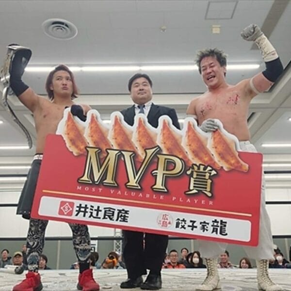 Superluchas - Dos hombres parados junto a un cartel que dice MVP.